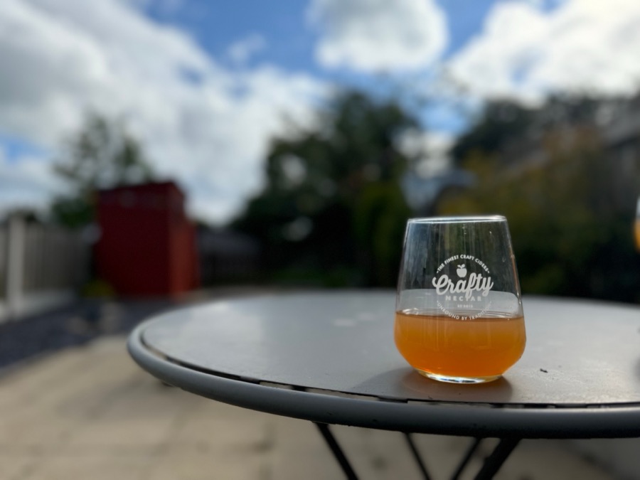 A Crafty Nectar glass of cider on a garden table