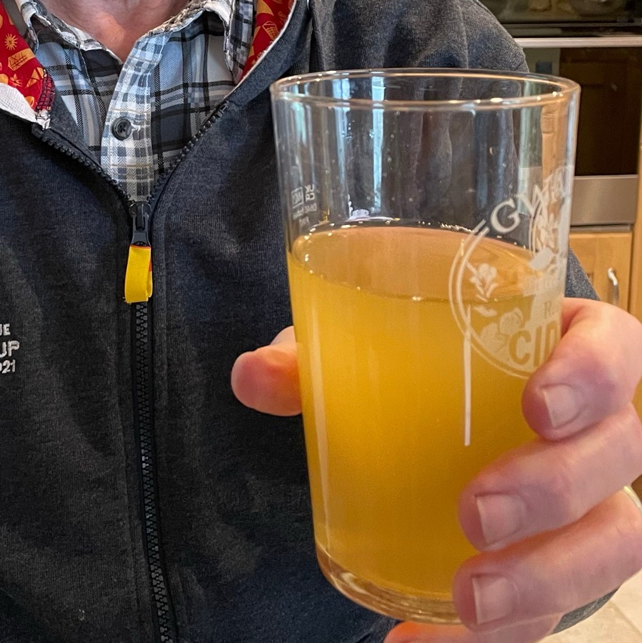 A glass of cloudy cider in a Gwatkin pint glass