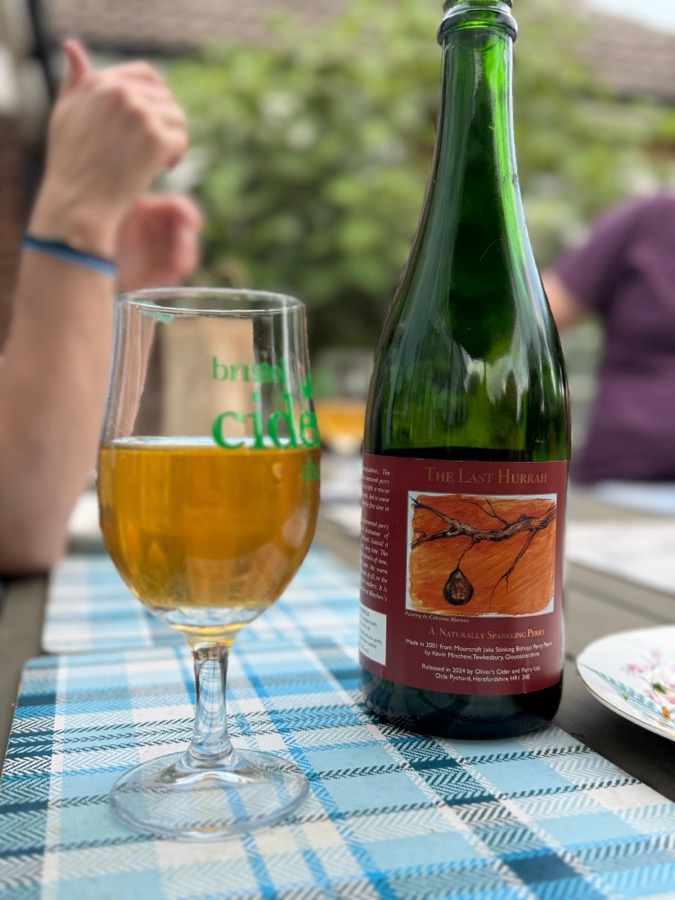 A bottle of The Last Hurrah sparkling perry beside a glass
